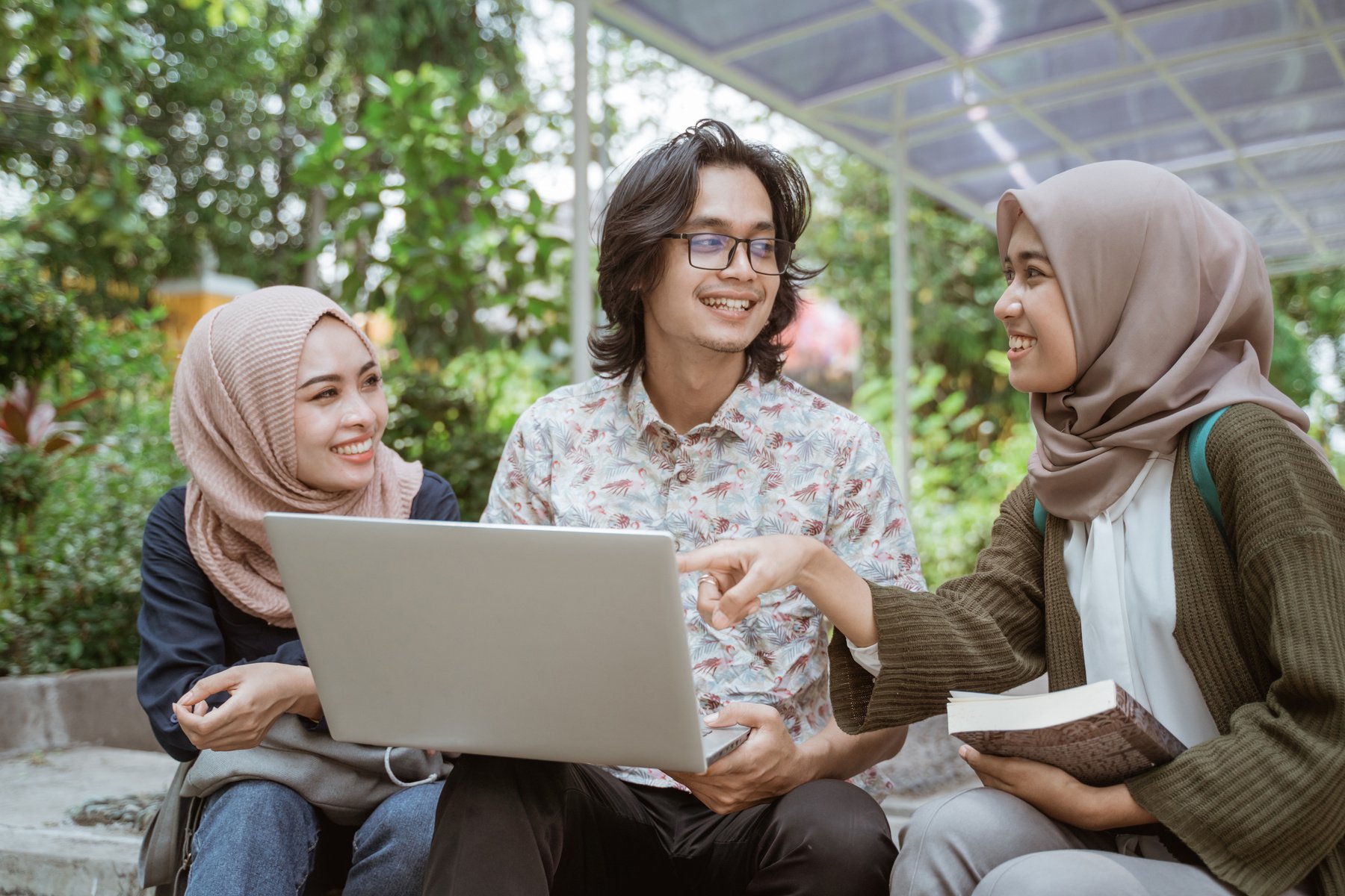 Portrait Students Discussing Together with Laptop